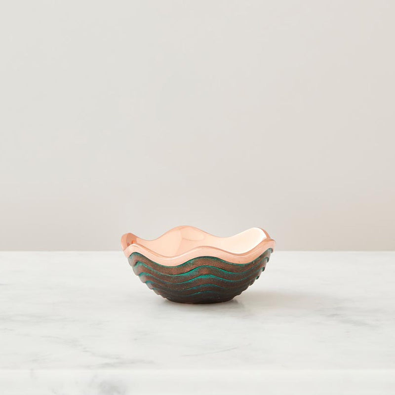 Nambé Copper Canyon Bowl in a display setting; other items shown are sold separately.